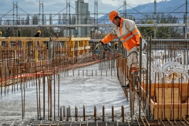 Worker man spraying concrete surface with Sika® Antisol® concrete curing compound